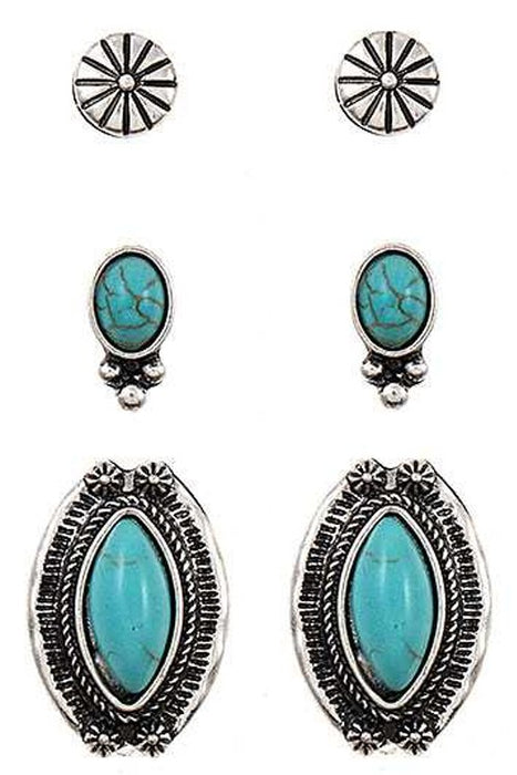 Set of silver and turquoise earrings on a white background