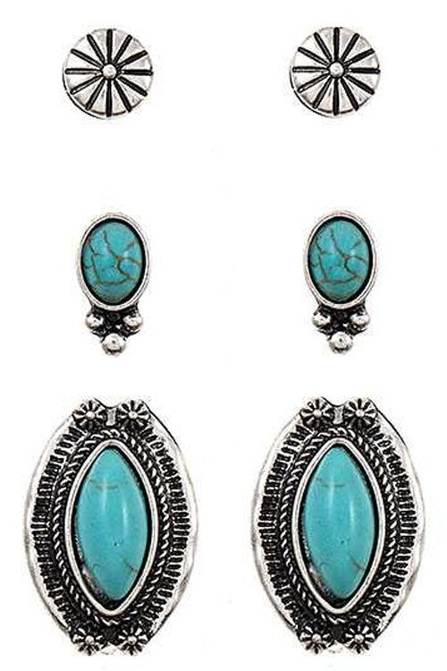 Set of silver and turquoise earrings on a white background
