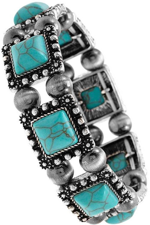 Bracelet with turquoise stones and silver accents on a white background