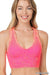 Woman wearing a pink sports bra with a white background