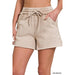 Beige shorts with drawstring on a white background