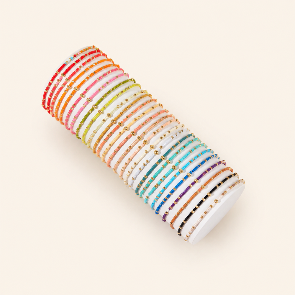 Colorful beaded bracelets on warm cream background