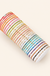 Colorful beaded bracelets on warm cream background