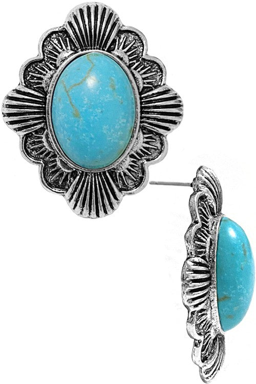 Pair of earrings with turquoise stones and silver floral designs on a white background