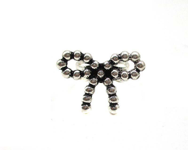 Silver bow-shaped charm with rhinestones on a white background