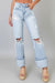 Light blue distressed jeans worn by a person on a white background