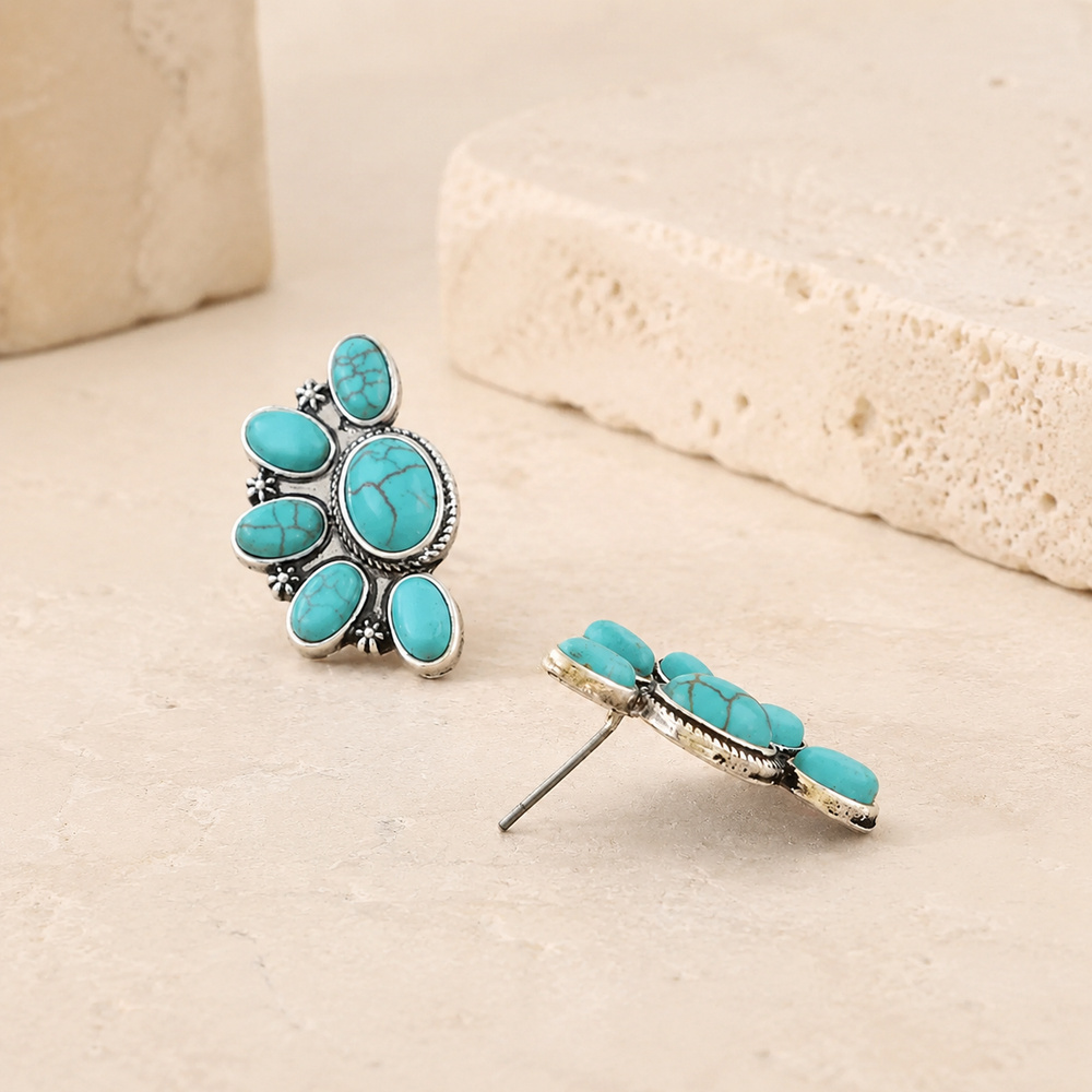 Antique Half Flower Stud Earrings on cream stone display