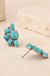 Antique Half Flower Stud Earrings on cream stone display