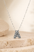 Checkered Bubble Initial Necklace on cream stone display