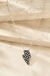 Checkered Lightning Bolt Necklace on cream stone background