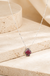 Checkered Spade Necklace on cream stone background