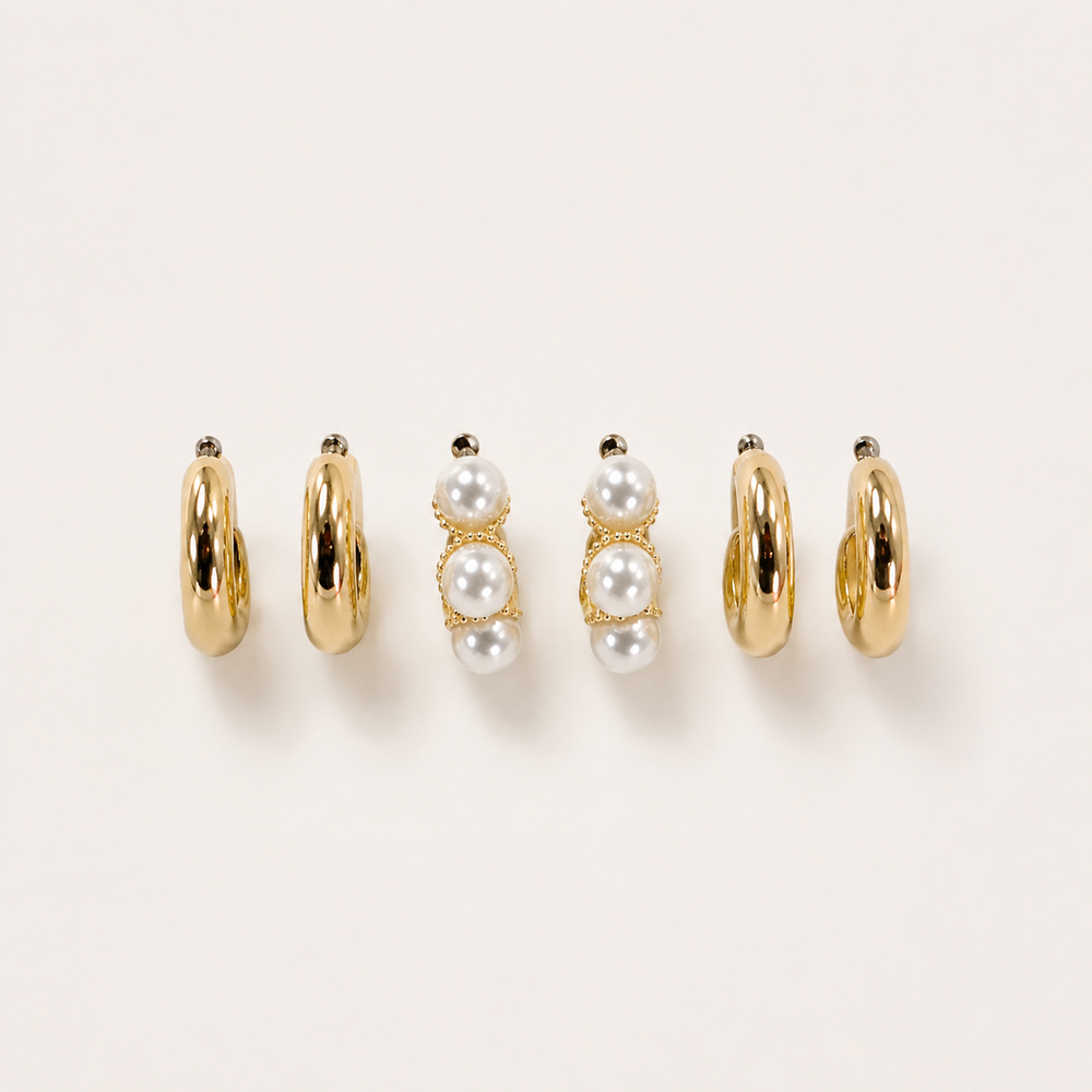 Huggie Pearl Gold Hoop Earrings Trio Set on soft-white background