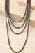Multi Layered Tiny Western Navajo Pearl Necklace on cream stone display