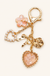 Pressed Flower Bow Pearl Heart Bag Charm on soft-white background