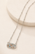 Silver Camo Necklace on a warm cream stone display