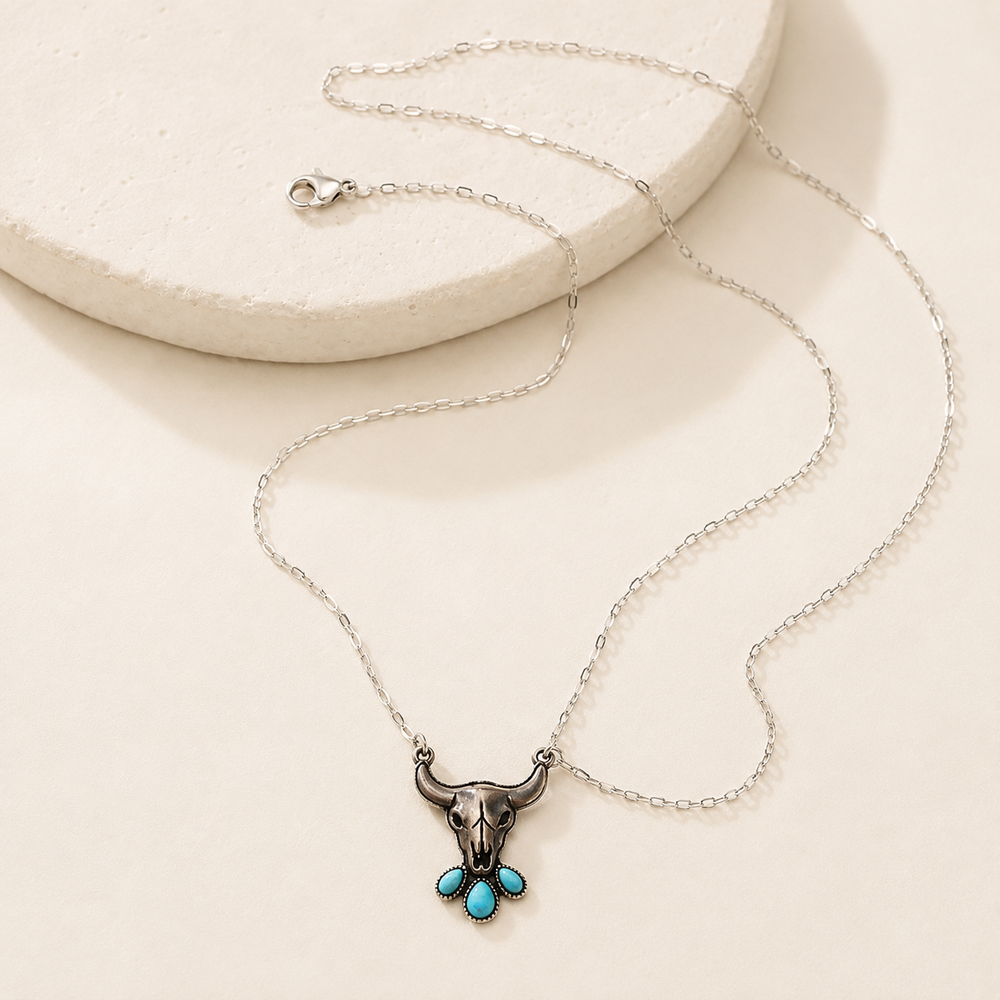 Western Steerhead Turquoise Pendant Necklace on a warm cream stone display