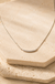 Sterling Silver Bar Necklace on cream stone background