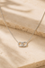 Sterling Silver Double Halo Necklace on cream stone background