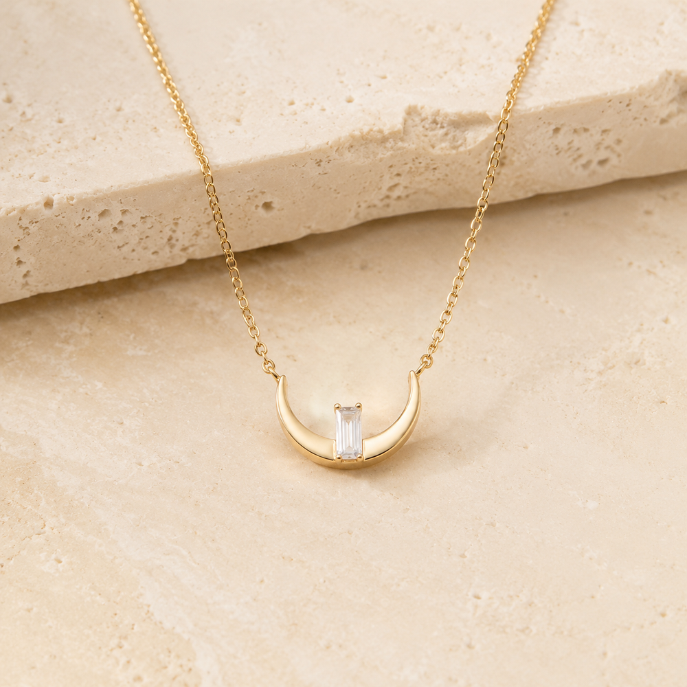 Sterling Silver Half Moon Necklace on cream stone background