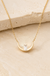 Sterling Silver Half Moon Necklace on cream stone background