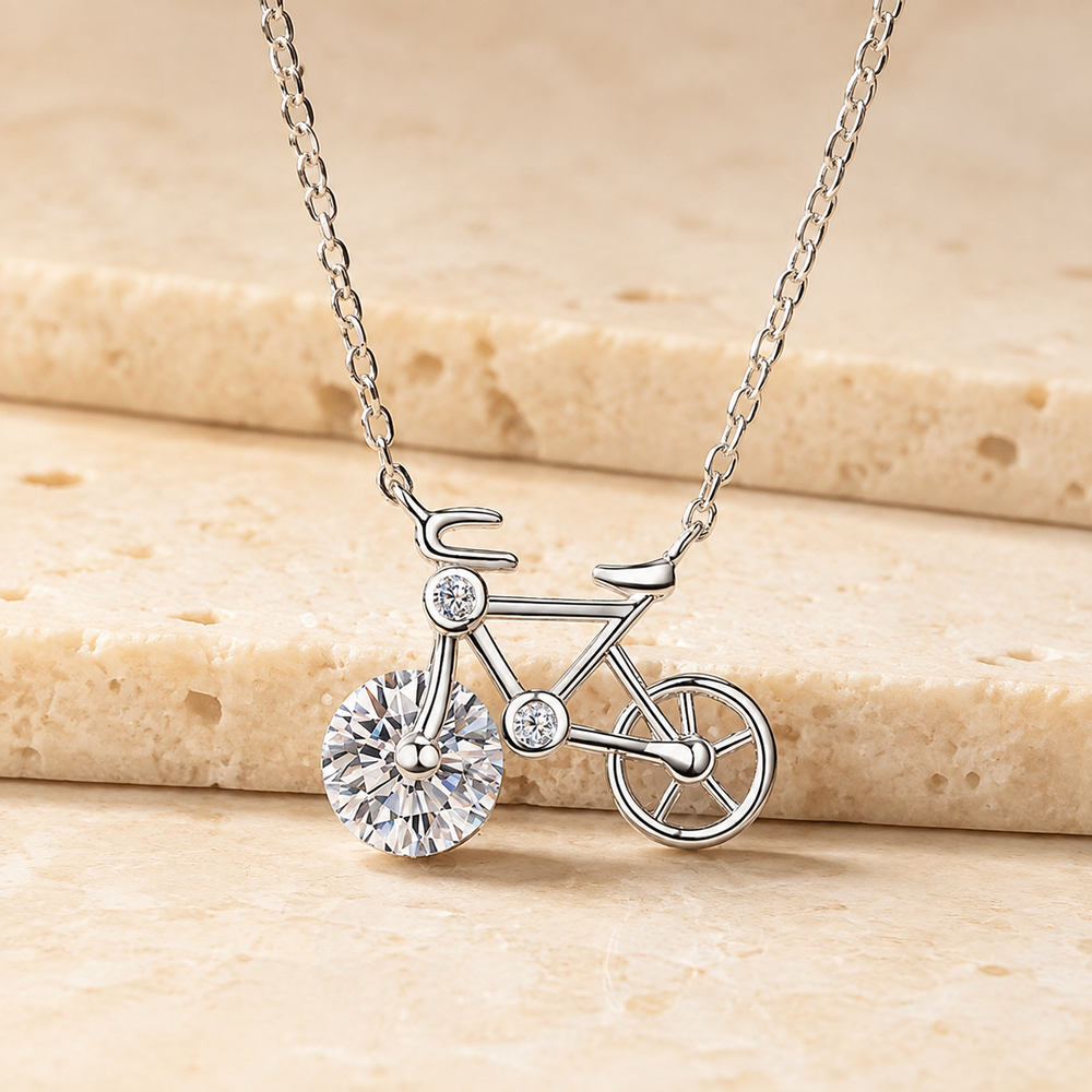 Sterling Silver Moissanite Bicycle Pendant Necklace on cream stone background