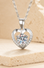Sterling Silver Moissanite Heart Pendant Necklace on cream stone background