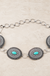 Texture Western Concho Oval Gem Stone Chain Belt on cream stone