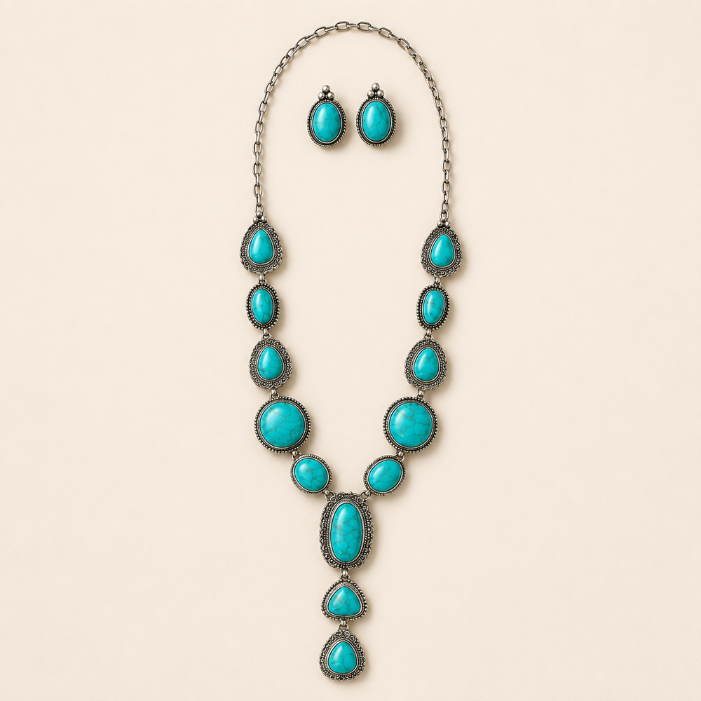 Western concho turquoise lariat necklace and earrings on ivory background