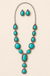 Western concho turquoise lariat necklace and earrings on ivory background