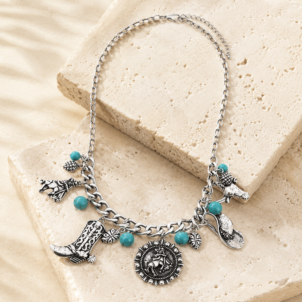 Western Cowboy Hat Boot Tq Charm Chain Necklace on cream stone display