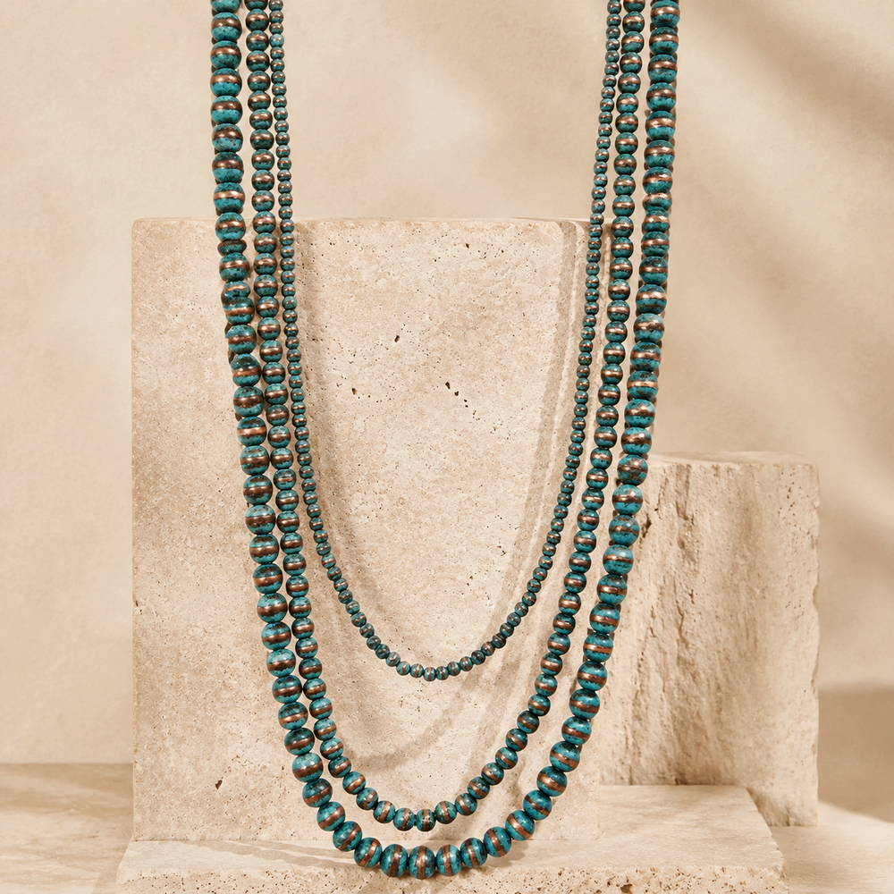 Western Multi Stand Navajo Pearl Long Necklace on cream stone background