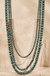 Western Multi Stand Navajo Pearl Long Necklace on cream stone background