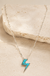 Western Turquoise Thunderbolt Necklace on cream stone display