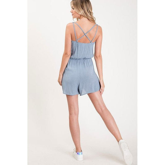 Textured solid color spaghetti strap jumpsuit with drawstring waist.
