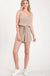 Textured solid color spaghetti strap jumpsuit with drawstring waist. LECCE